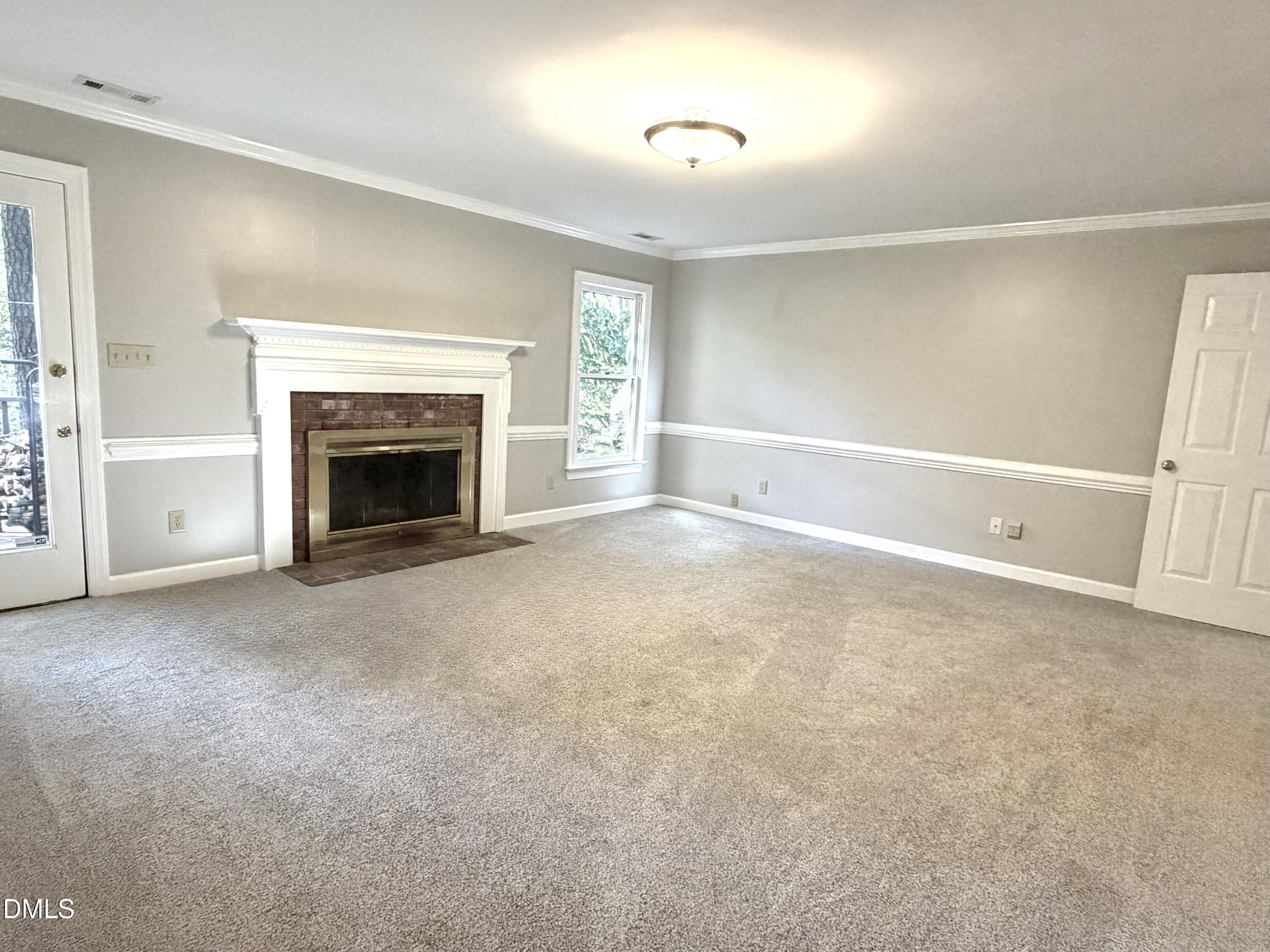 4907 Fortunes Ridge Drive Durham, NC 27713 - Photo 11 of 43 a view of empty room with a fireplace