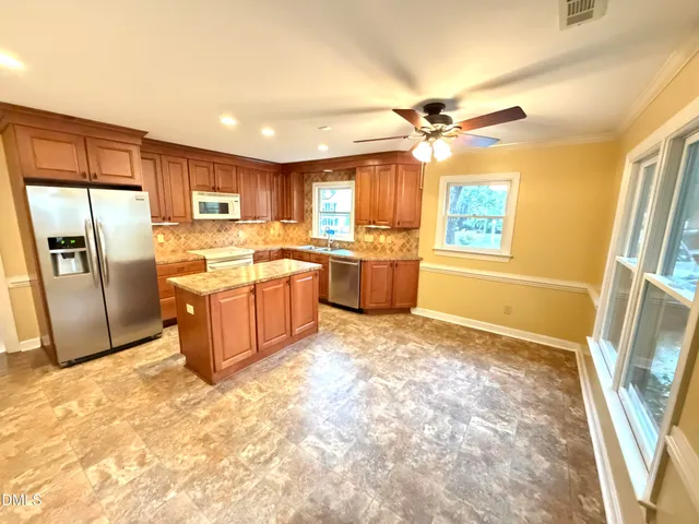 a kitchen with granite countertop a sink and a stove
