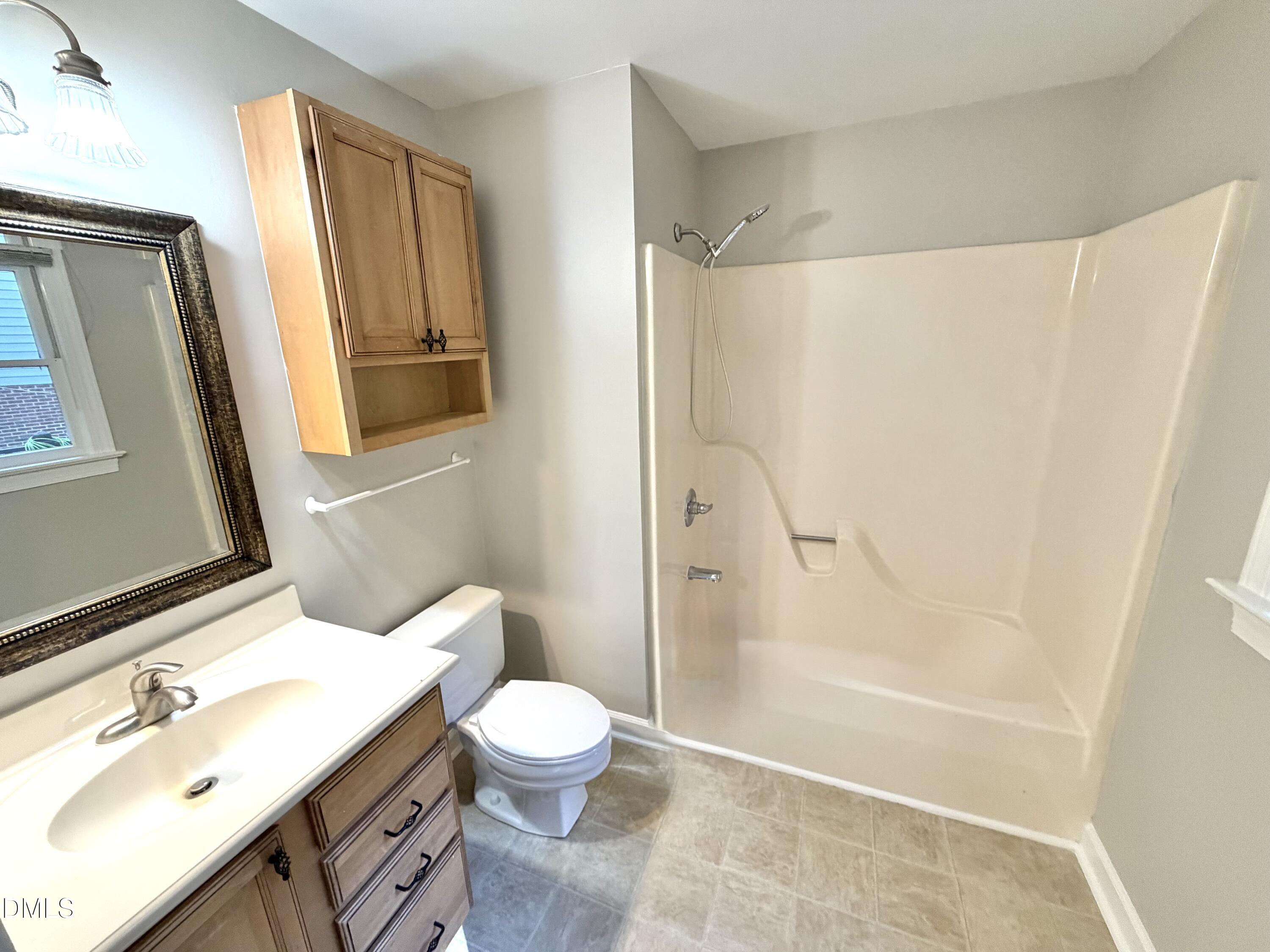4907 Fortunes Ridge Drive Durham, NC 27713 - Photo 23 of 43 a bathroom with a sink a toilet and shower