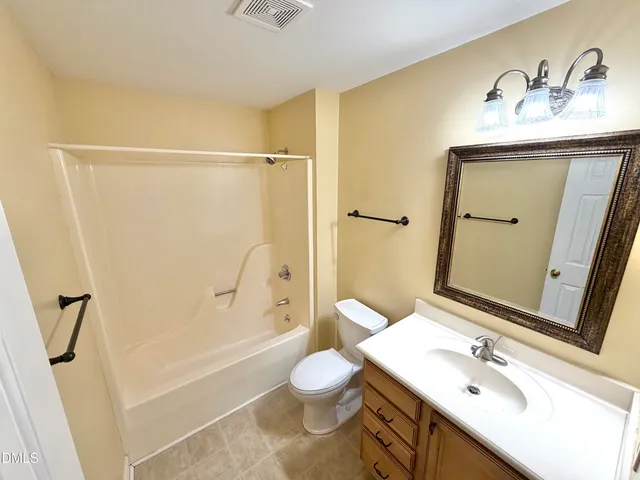 a view of a room with a table and chairs