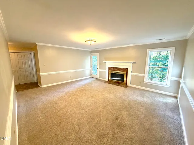 a view of empty room with a fireplace
