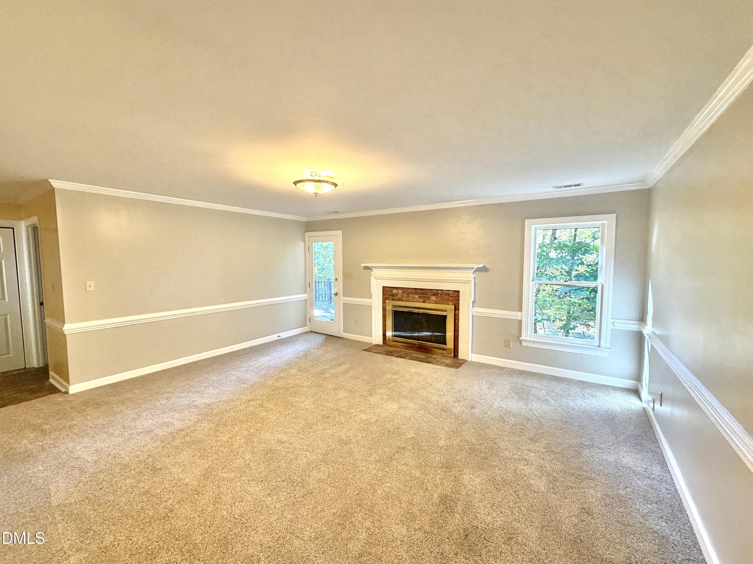 4907 Fortunes Ridge Drive Durham, NC 27713 - Photo 9 of 43 a view of an empty room with a fireplace and a window