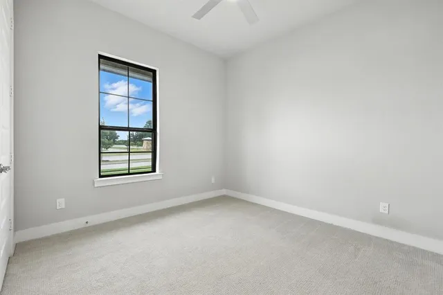 a kitchen with a refrigerator and cabinets