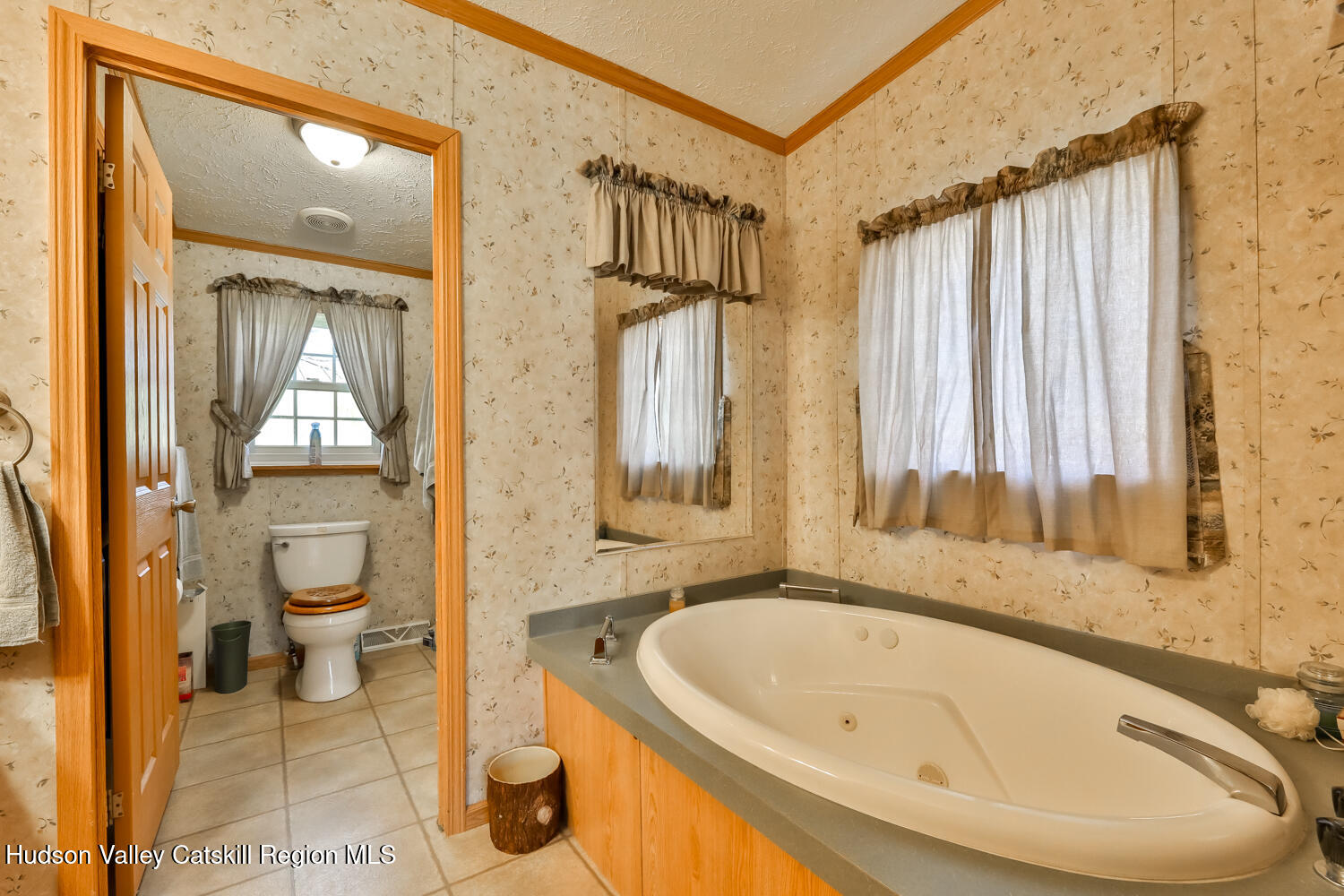 751 Mitchell Hollow Road Windham, NY 12496 - Photo 28 of 37 a bathroom with a granite countertop sink and a large mirror