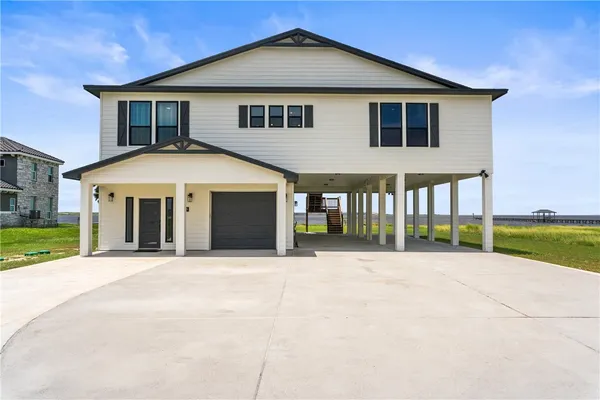 a front view of a house with a yard and porch