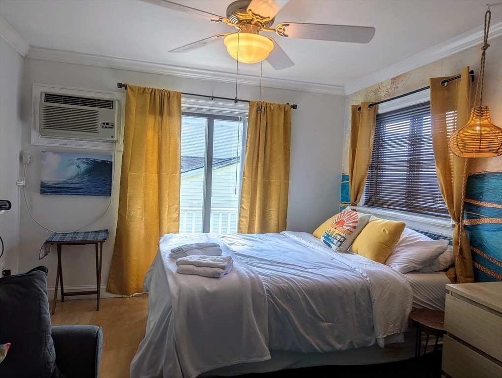 415 Ocean Boulevard, Unit 306 Hampton, NH 03842 - Photo 3 of 11 a bedroom with a bed and a window