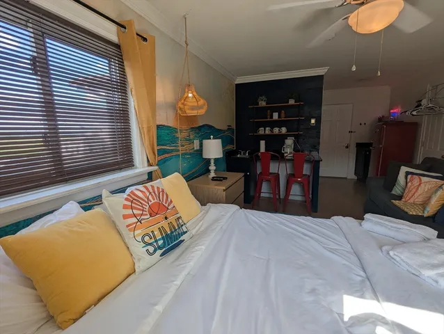 a bed sitting in a bedroom next to a window