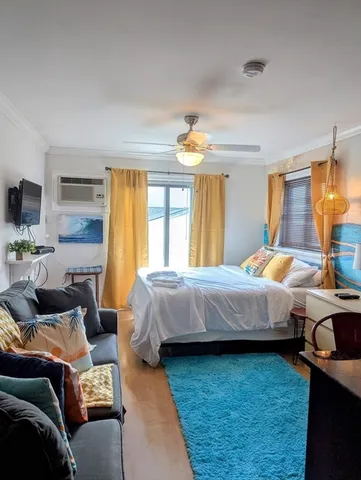 a bedroom with a bed and wooden floor