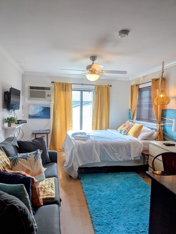 415 Ocean Boulevard, Unit 306 Hampton, NH 03842 - Photo 6 of 11 a bedroom with a bed and wooden floor