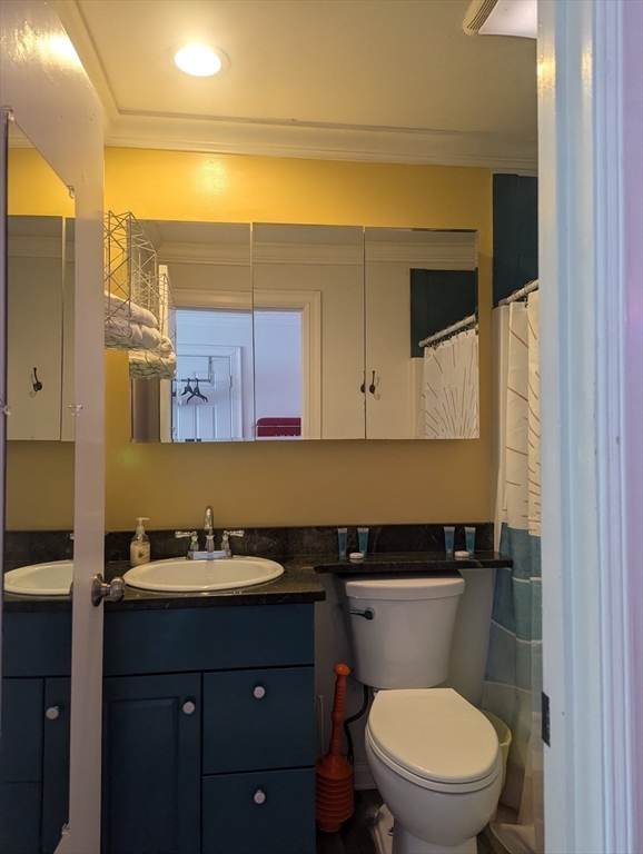 415 Ocean Boulevard, Unit 306 Hampton, NH 03842 - Photo 10 of 11 a bathroom with a granite countertop toilet sink and mirror