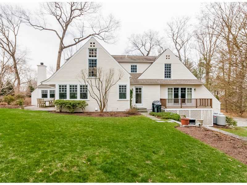 22 Indian Spring Road Rowayton, CT 06853 - Photo 20 of 23 a front view of a house with a yard and trees