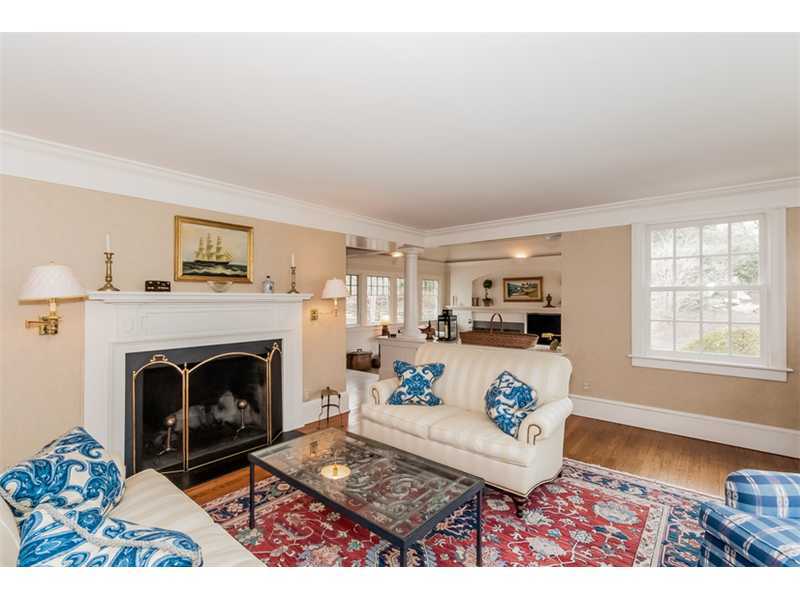 22 Indian Spring Road Rowayton, CT 06853 - Photo 3 of 23 a living room with furniture a fireplace and a table