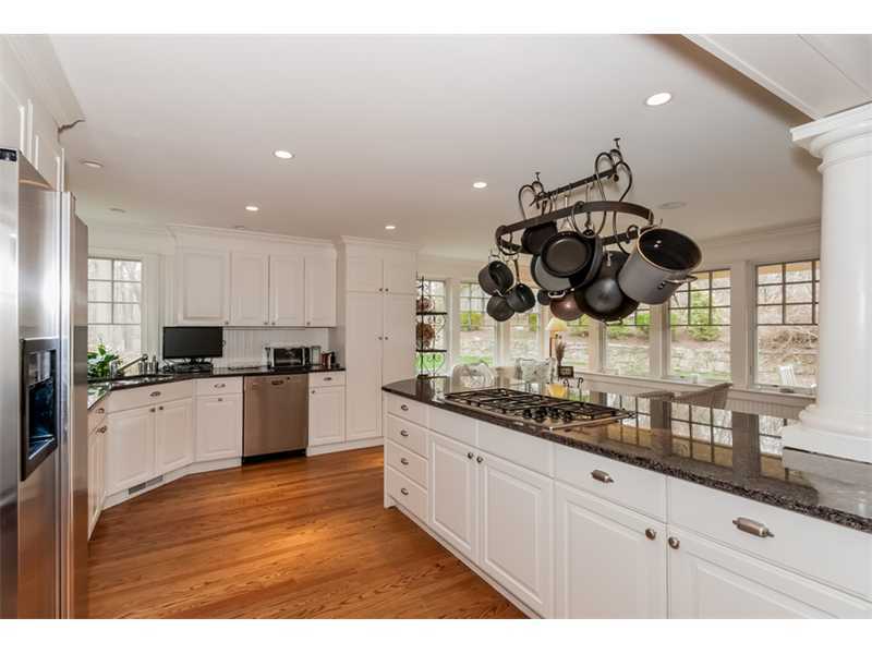 22 Indian Spring Road Rowayton, CT 06853 - Photo 9 of 23 a kitchen with stainless steel appliances granite countertop a sink a stove and a wooden floors