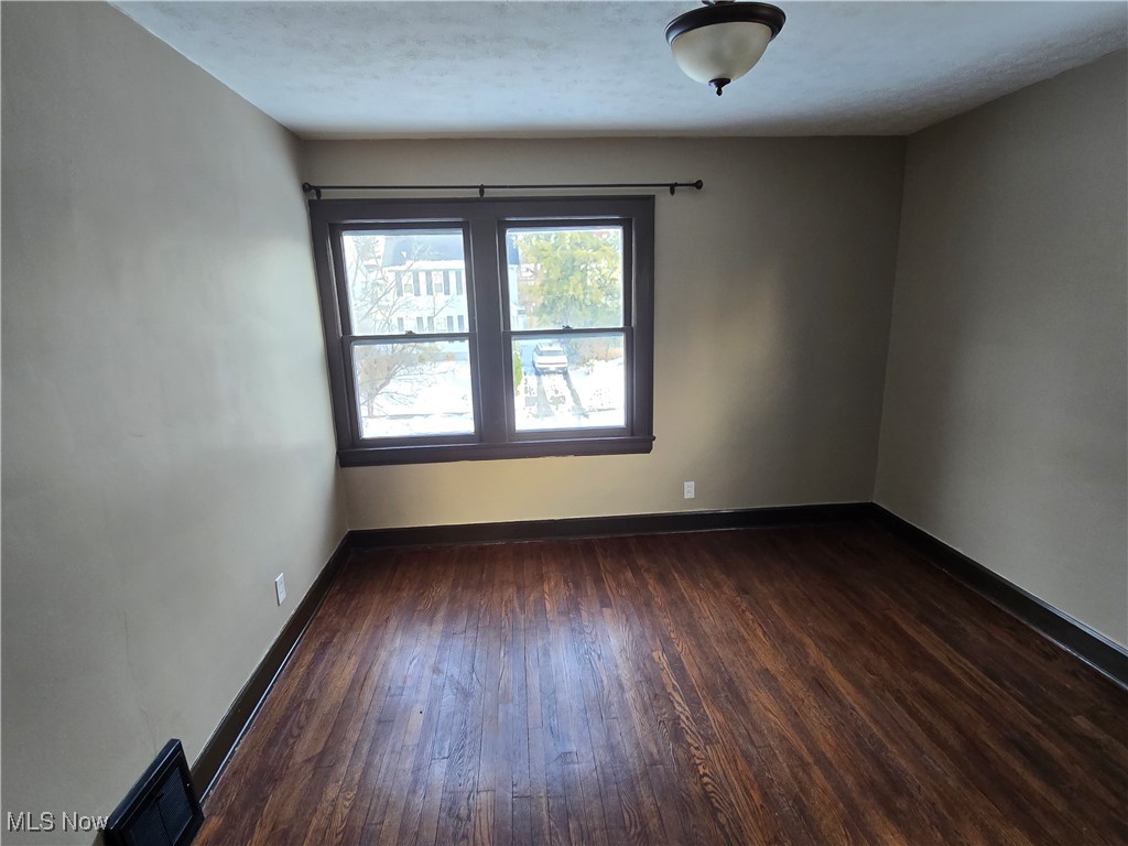 2048 Rossmoor Road Cleveland Heights, OH 44118 - Photo 21 of 29 Unfurnished room featuring baseboards and dark wood finished floors