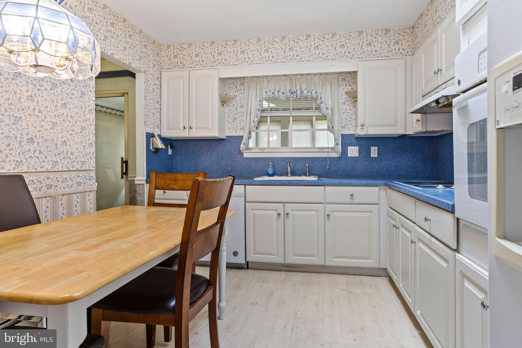 915 Ash Road Wallingford, PA 19086 - Photo 7 of 28 a kitchen with a table chairs sink and cabinets