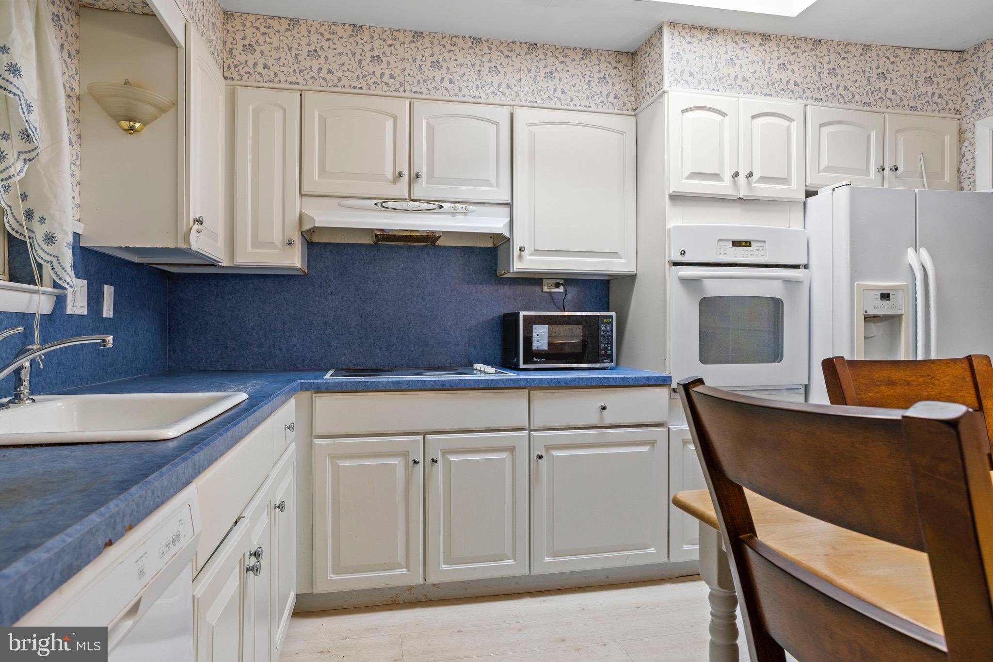 915 Ash Road Wallingford, PA 19086 - Photo 8 of 28 a kitchen with stainless steel appliances granite countertop white cabinets and sink