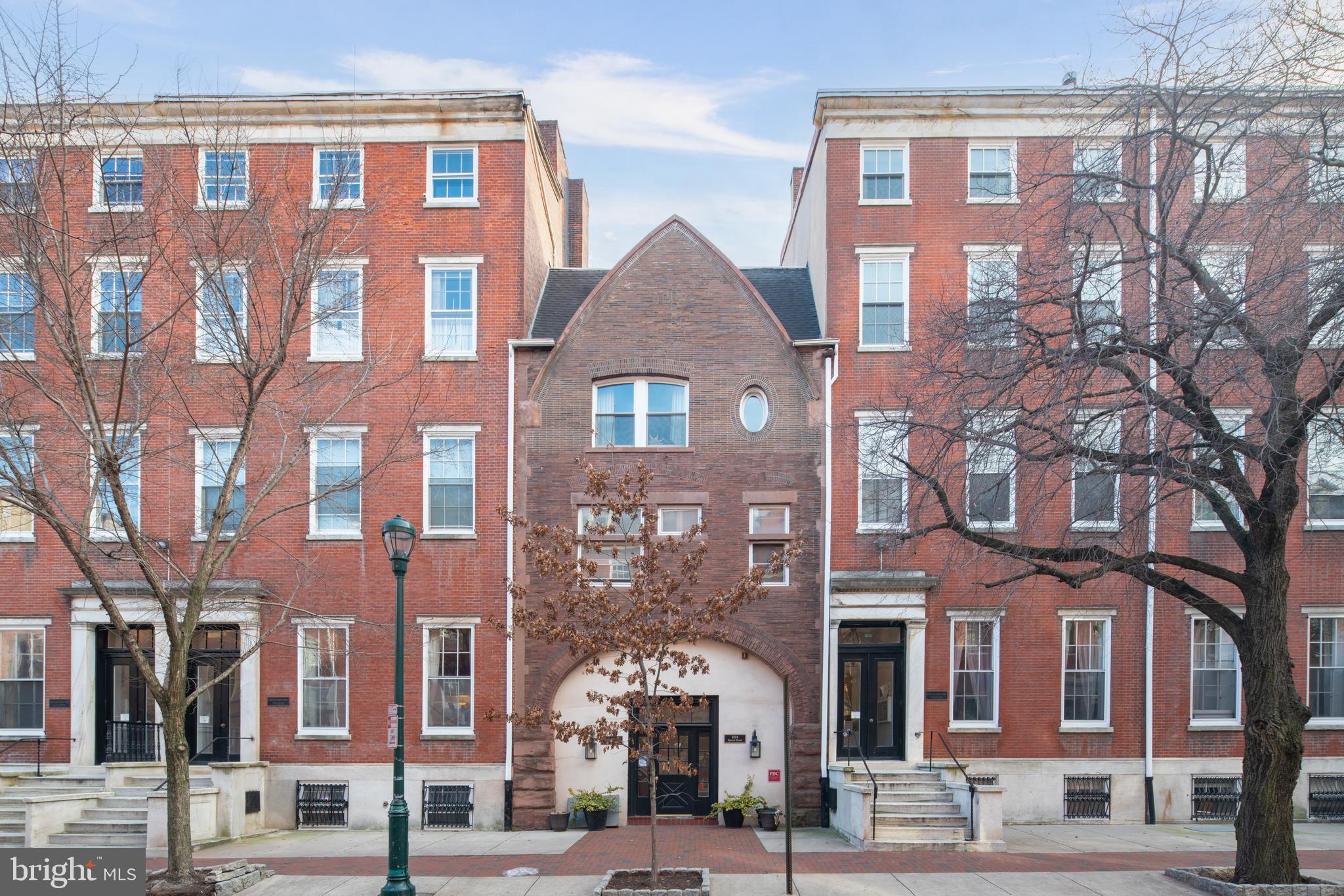 1008 Spruce Street, Unit 21 Philadelphia, PA 19107 - Photo 1 of 16 a front view of a brick building next to a yard