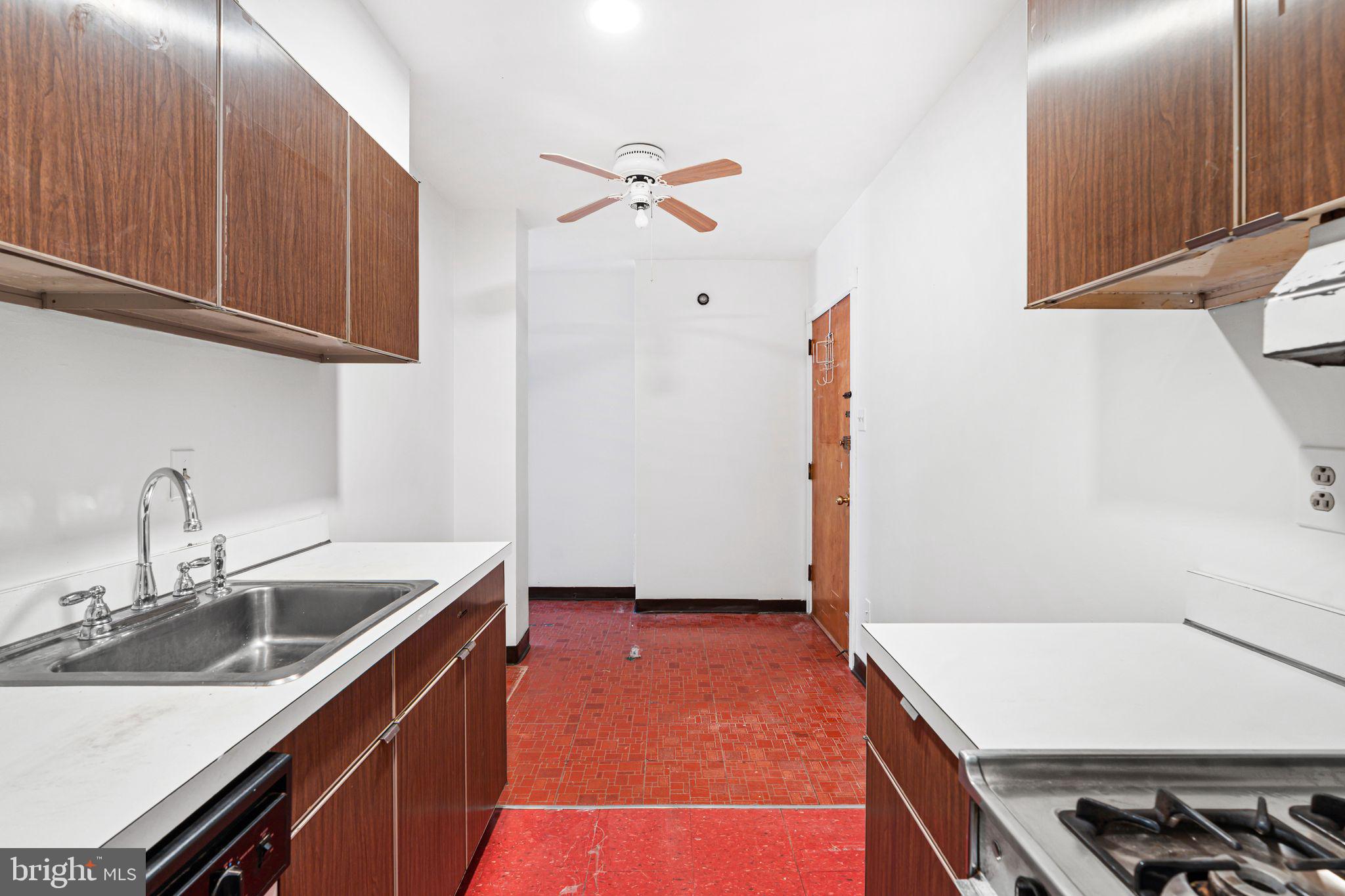 1008 Spruce Street, Unit 21 Philadelphia, PA 19107 - Photo 7 of 16 a kitchen with a sink a stove and cabinets