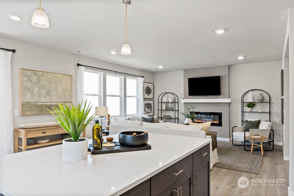 616 185th Street Southwest, Unit NCV24 Bothell, WA 98012 - Photo 11 of 25 a kitchen with a stove a sink and a living room