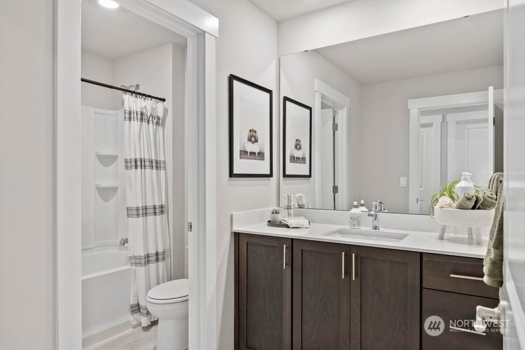 616 185th Street Southwest, Unit NCV24 Bothell, WA 98012 - Photo 16 of 25 a bathroom with a double vanity sink toilet and shower