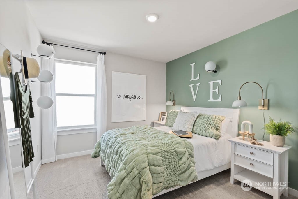 616 185th Street Southwest, Unit NCV24 Bothell, WA 98012 - Photo 17 of 25 a bedroom with a bed a mirror and a window