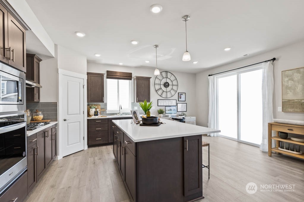 616 185th Street Southwest, Unit NCV24 Bothell, WA 98012 - Photo 8 of 25 a kitchen with stainless steel appliances granite countertop a sink stove and refrigerator
