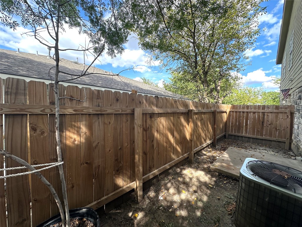 2203 Creekside Lane, Unit A Georgetown, TX 78626 - Photo 14 of 14 a view of a backyard with wooden fence and a bench