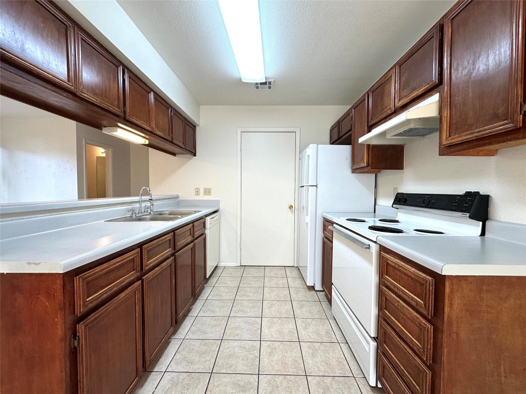 2203 Creekside Lane, Unit A Georgetown, TX 78626 - Photo 5 of 14 a kitchen with stainless steel appliances granite countertop a sink and a stove