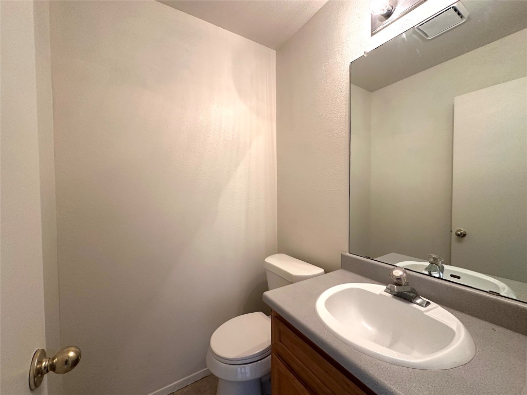 2203 Creekside Lane, Unit A Georgetown, TX 78626 - Photo 7 of 14 a bathroom with a sink a toilet and mirror