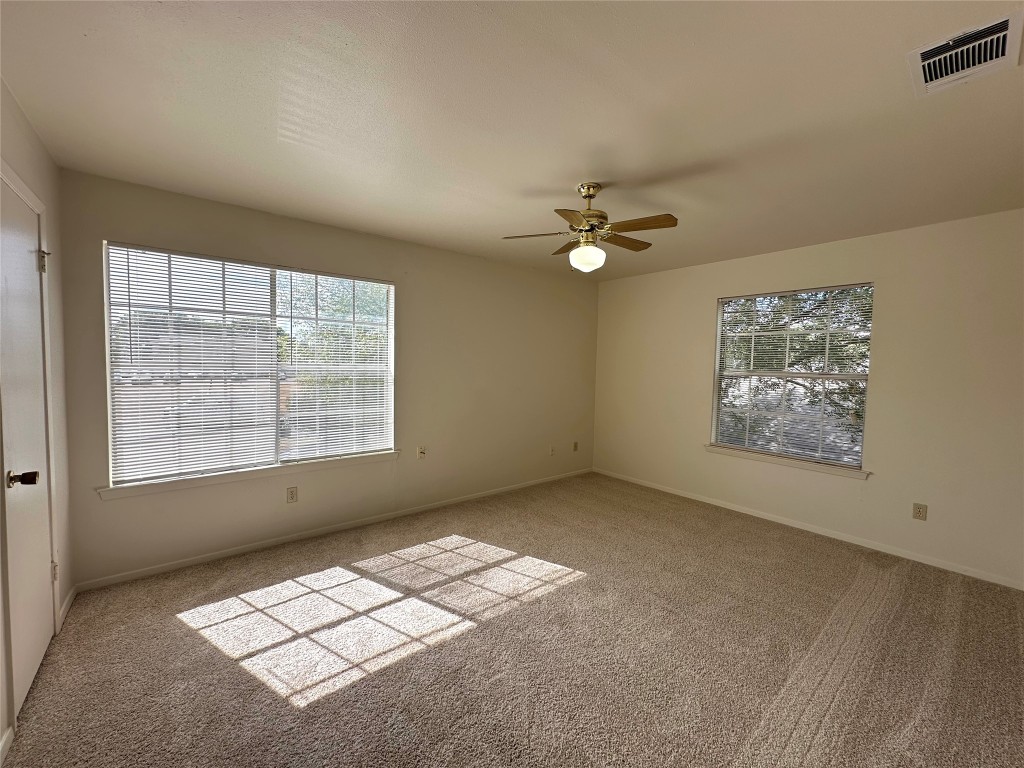 2203 Creekside Lane, Unit A Georgetown, TX 78626 - Photo 10 of 14 an empty room with windows and ceiling fan