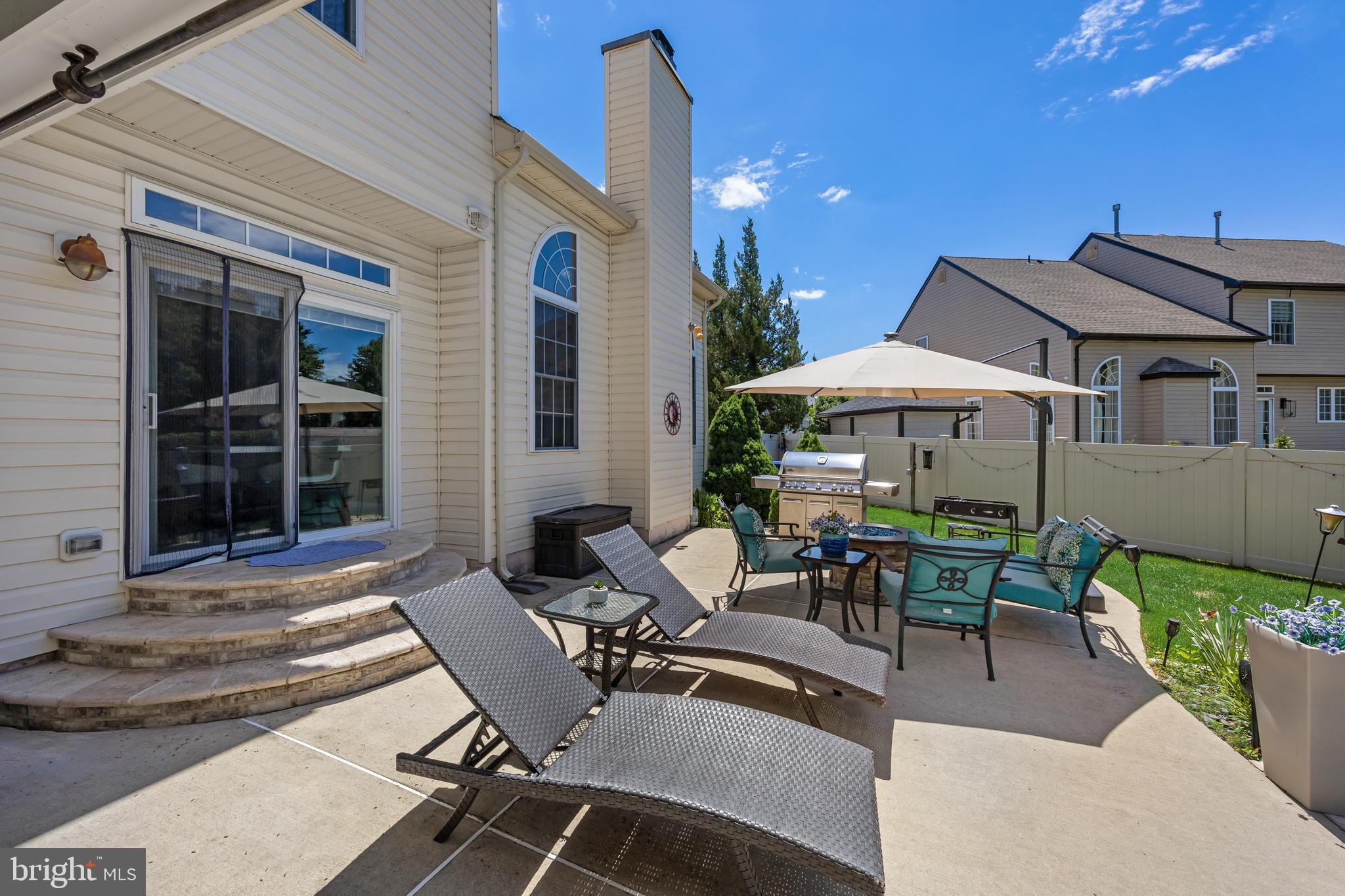 2 Rothbury Drive Lumberton, NJ 08048 - Photo 45 of 54 a view of a patio with table and chairs under an umbrella