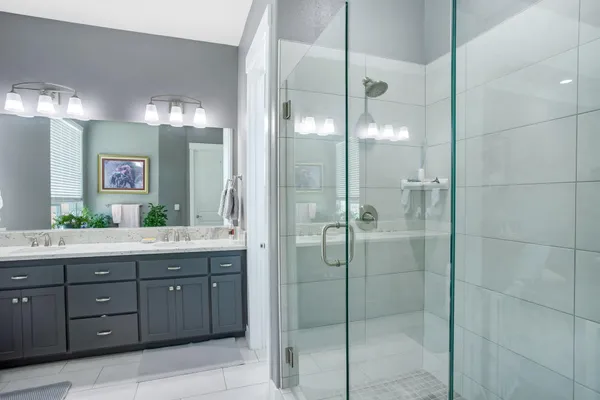 a bathroom with a shower sink and mirror