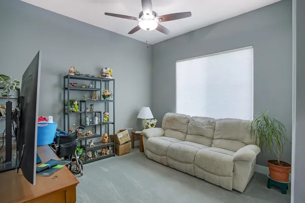 a living room with furniture a rug and a chandelier
