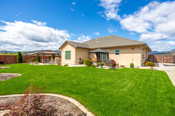 a front view of a house with a garden