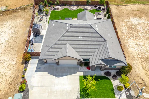 an aerial view of a house with garden space and street view