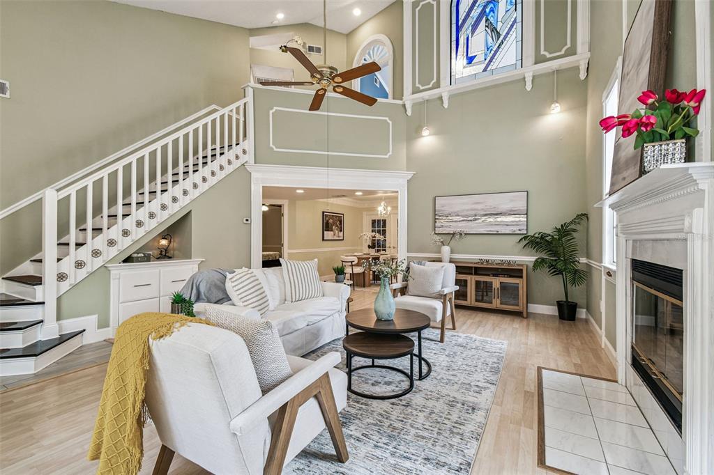 7115 Hummingbird Lane New Port Richey, FL 34655 - Photo 12 of 75 a living room with furniture a fireplace and a potted plant