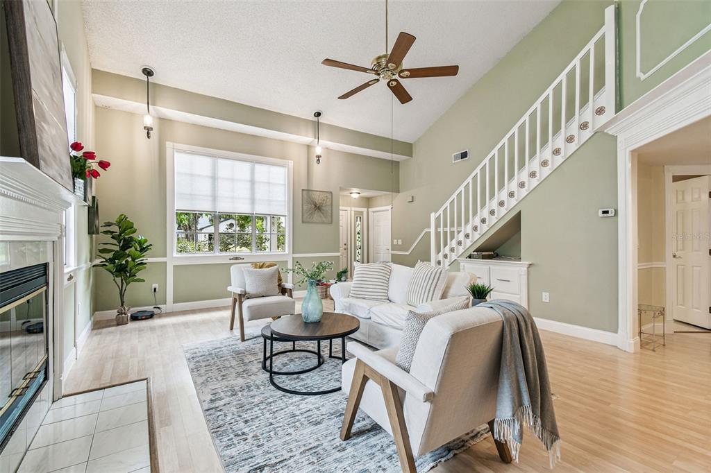 7115 Hummingbird Lane New Port Richey, FL 34655 - Photo 13 of 75 a living room with furniture and a fireplace