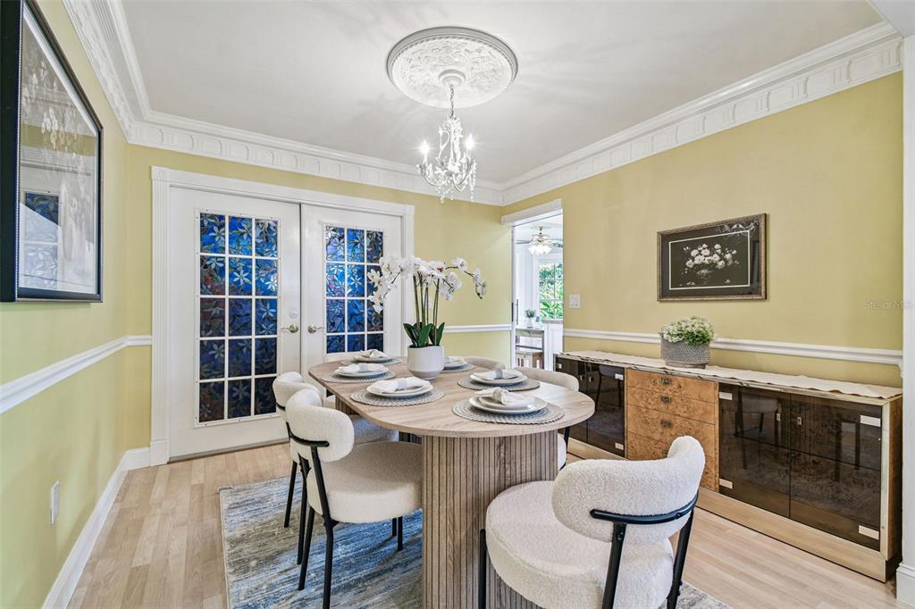 7115 Hummingbird Lane New Port Richey, FL 34655 - Photo 17 of 75 a view of a dining room with furniture window and wooden floor
