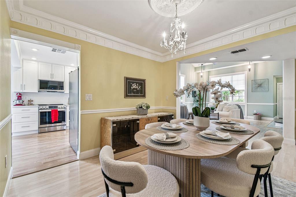7115 Hummingbird Lane New Port Richey, FL 34655 - Photo 19 of 75 a view of a dining room with furniture and wooden floor
