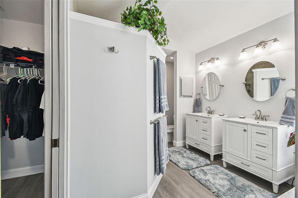 7115 Hummingbird Lane New Port Richey, FL 34655 - Photo 25 of 75 a bathroom with a double vanity sink and a mirror