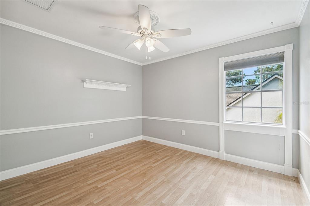 7115 Hummingbird Lane New Port Richey, FL 34655 - Photo 42 of 75 an empty room with a window and a fan