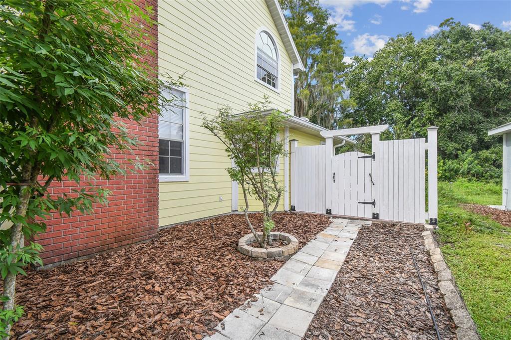 7115 Hummingbird Lane New Port Richey, FL 34655 - Photo 61 of 75 a backyard of a house with table and chairs
