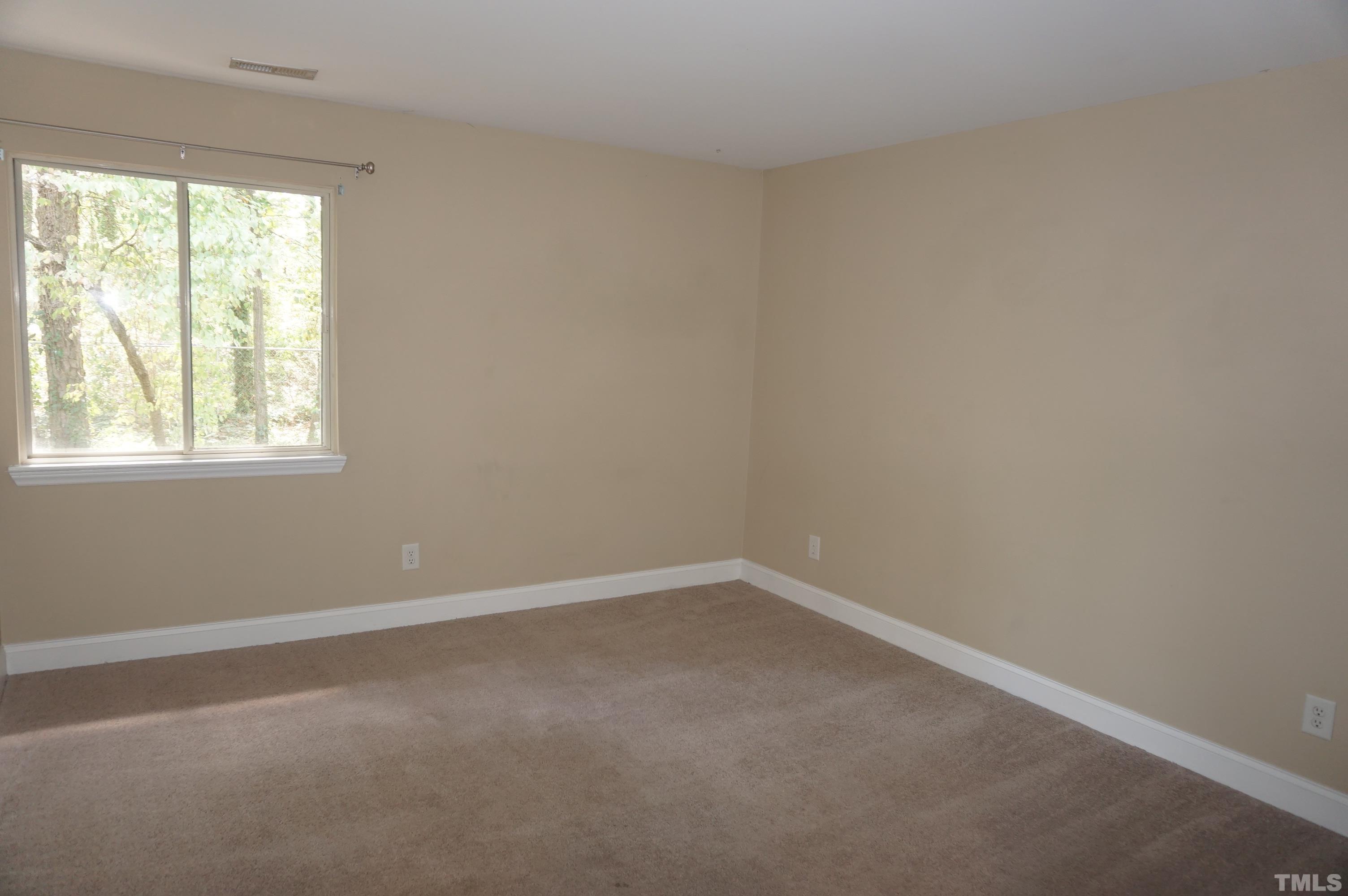 4505 Edwards Mill Road, Unit F Raleigh, NC 27612 - Photo 24 of 34 an empty room with a window