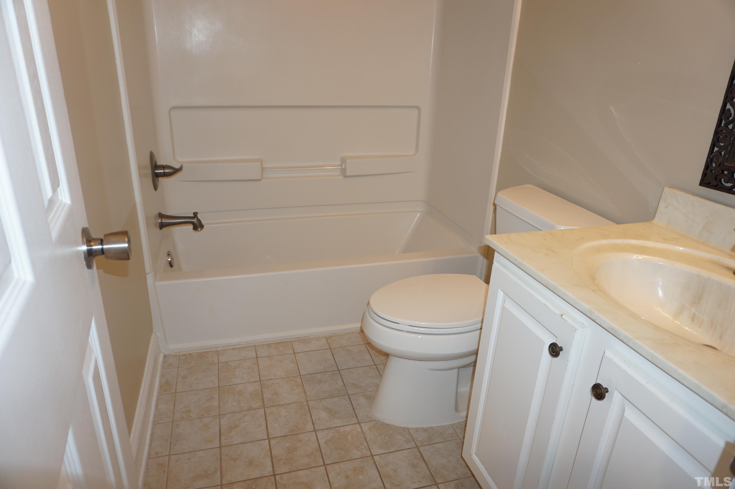 4505 Edwards Mill Road, Unit F Raleigh, NC 27612 - Photo 26 of 34 a bathroom with a sink a toilet and shower