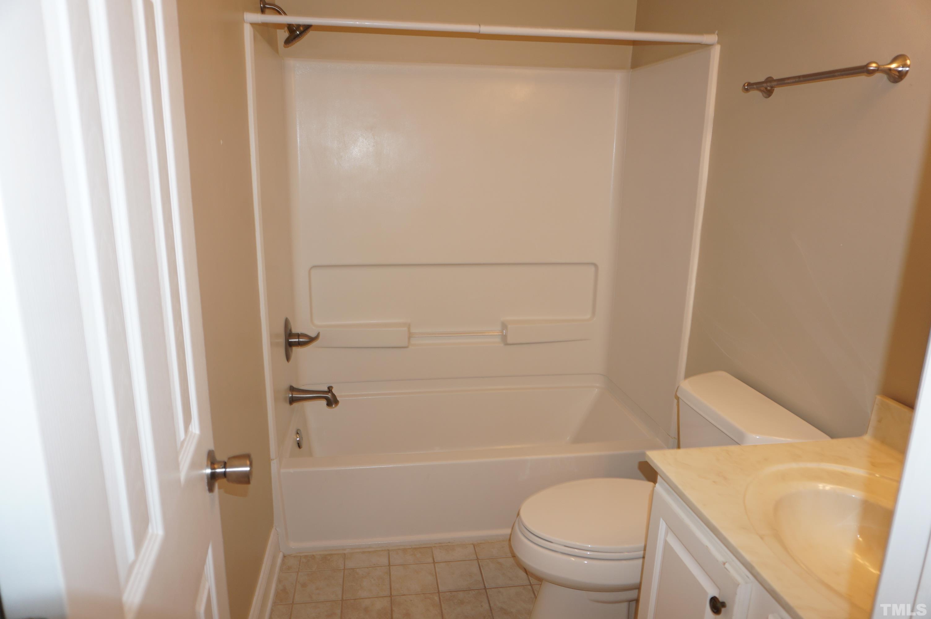 4505 Edwards Mill Road, Unit F Raleigh, NC 27612 - Photo 27 of 34 a bathroom with a shower and a toilet