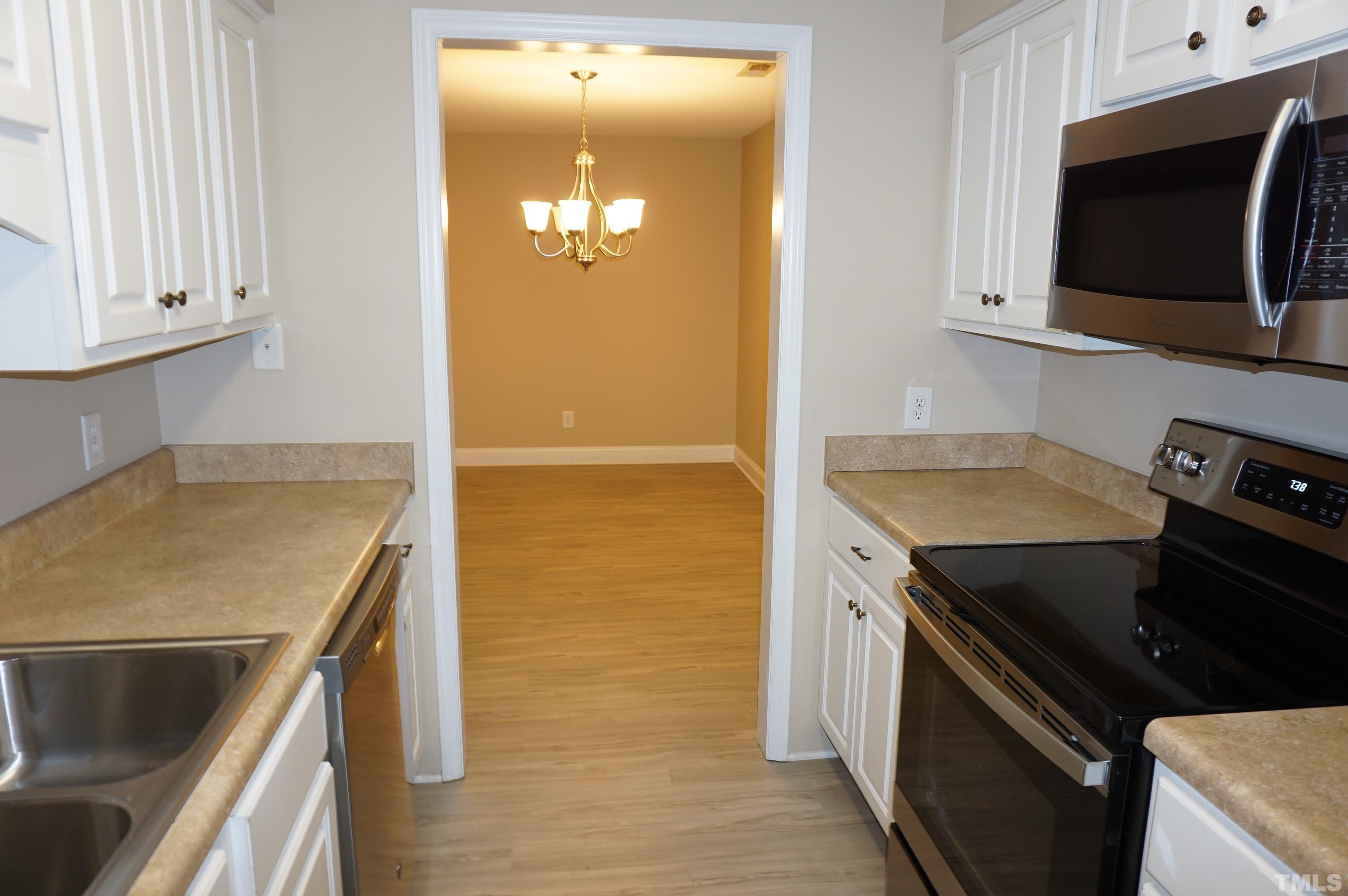 4505 Edwards Mill Road, Unit F Raleigh, NC 27612 - Photo 9 of 34 a kitchen with a sink and a stove top oven