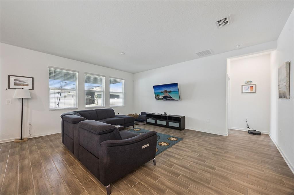 2714 Slash Way St. Cloud, FL 34771 - Photo 11 of 50 a living room with furniture and a wooden floor