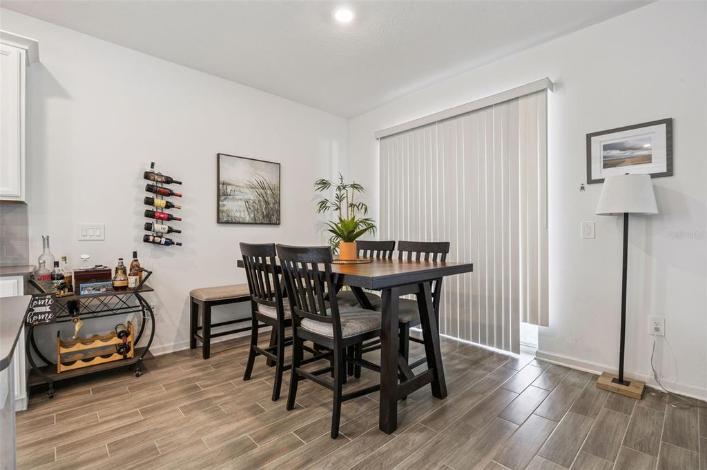 2714 Slash Way St. Cloud, FL 34771 - Photo 15 of 50 a view of a dining room with furniture and wooden floor