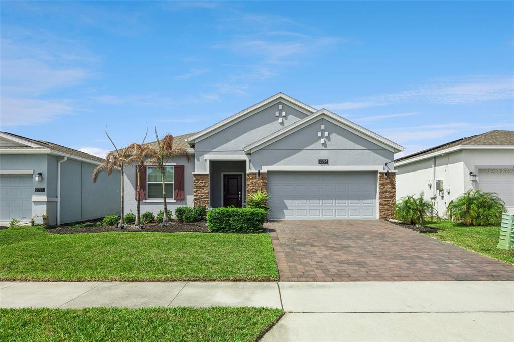 2714 Slash Way St. Cloud, FL 34771 - Photo 2 of 50 a front view of a house with a yard and garage