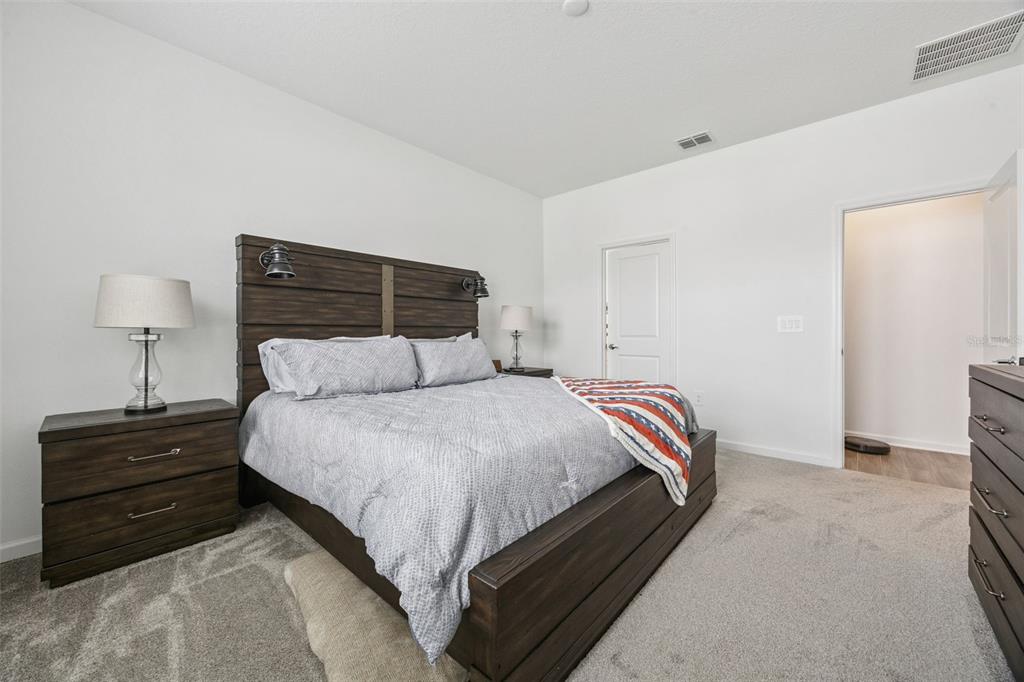 2714 Slash Way St. Cloud, FL 34771 - Photo 21 of 50 a bedroom with a bed and a lamp